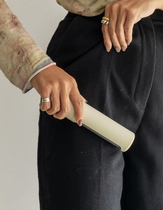 steamery_lint_brush_charcoal_sand_trousers_hand
